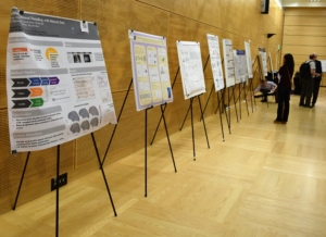 People gather around posters on easels. Photo, Robin Brooks, eScience Institute