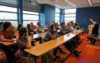 Postdoctoral fellows and graduate students gather for a career workshop featuring Tom Daniel. Photo by Robin Brooks