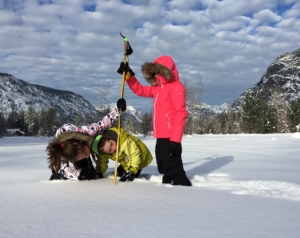 Figure 1: Fiona Hill, Josie Hill, and Tessa Hill use a tape measure and ski pole to measure the snow depth in Mazama, Washington. Photo credit: David Hill