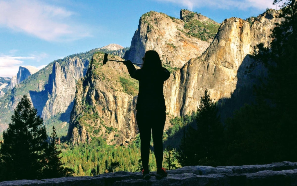 A woman takes a selfie at Yosemite National Park. Photo credit: Zsolt Palatinus, Pexels 