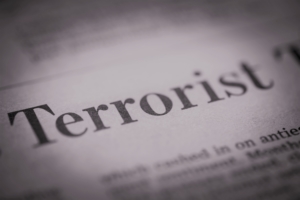 A black and white photo of the word "terrorist" printed on newspaper